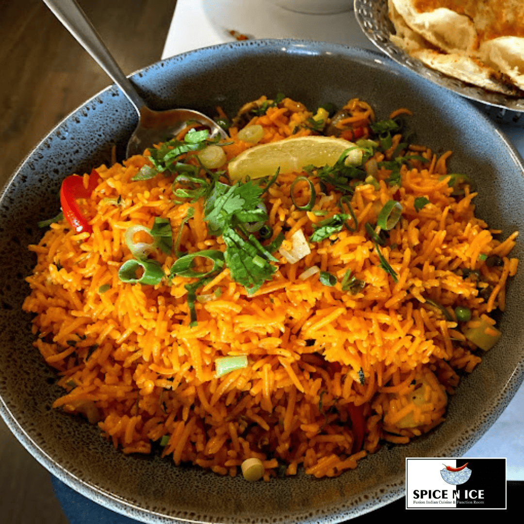 A plate of Biryani, a spiced mixed rice dish with meat and herbs.