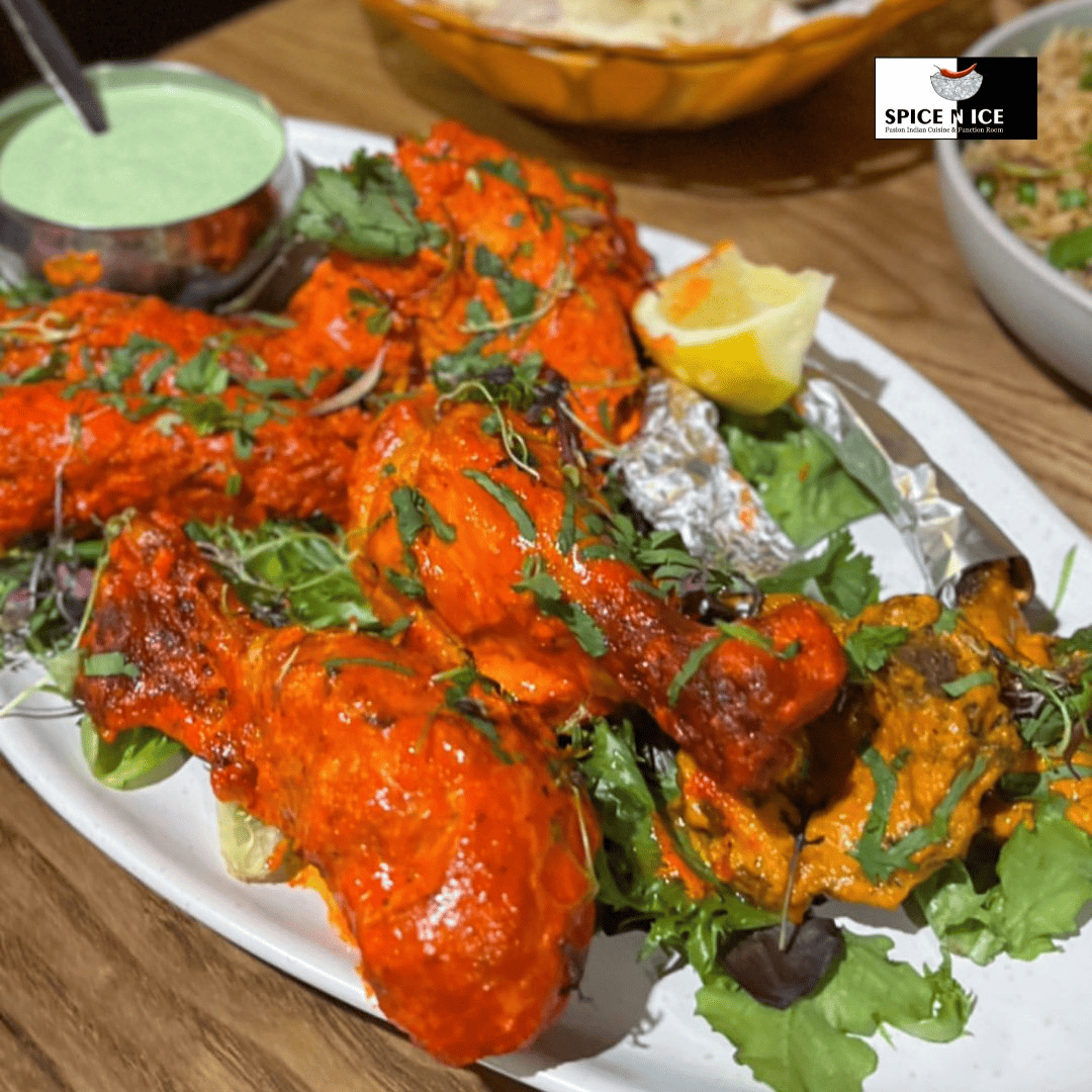 Grilled red-hued pieces of chicken on skewers, marinated in a blend of yogurt and tandoori spices.